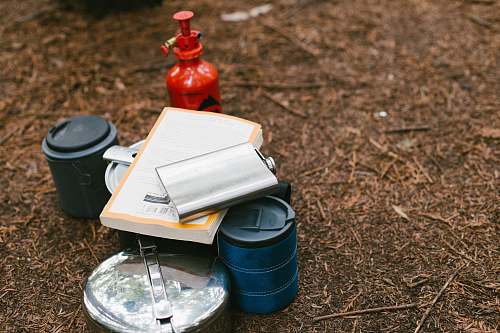 waterman gap trail camp flat lay photography of hip flask, book, tiffin carrier and container boulder creek